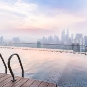 A rooftop swimming pool with a city skyline view