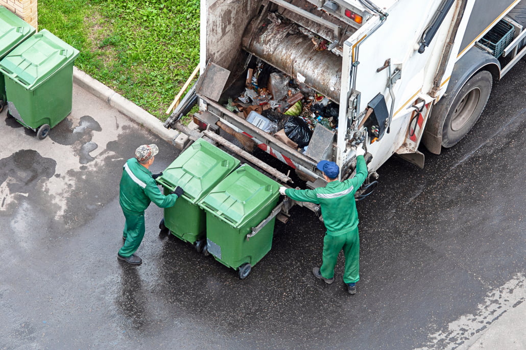 two workers loading mixed domestic waste in waste collection truck two workers loading mixed domestic waste in waste collection truck