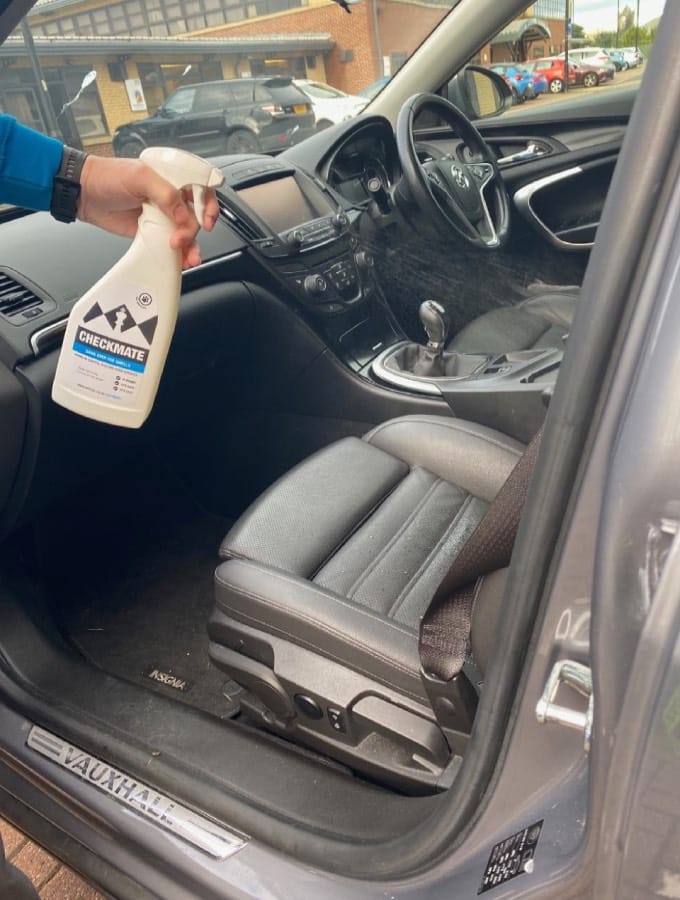 Spraying car with checkmate - 2 A person spraying car with enzyme odour eliminator