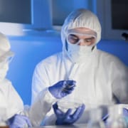 Close up photo of scientists with test samples inside lab