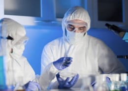 Close up photo of scientists with test samples inside lab